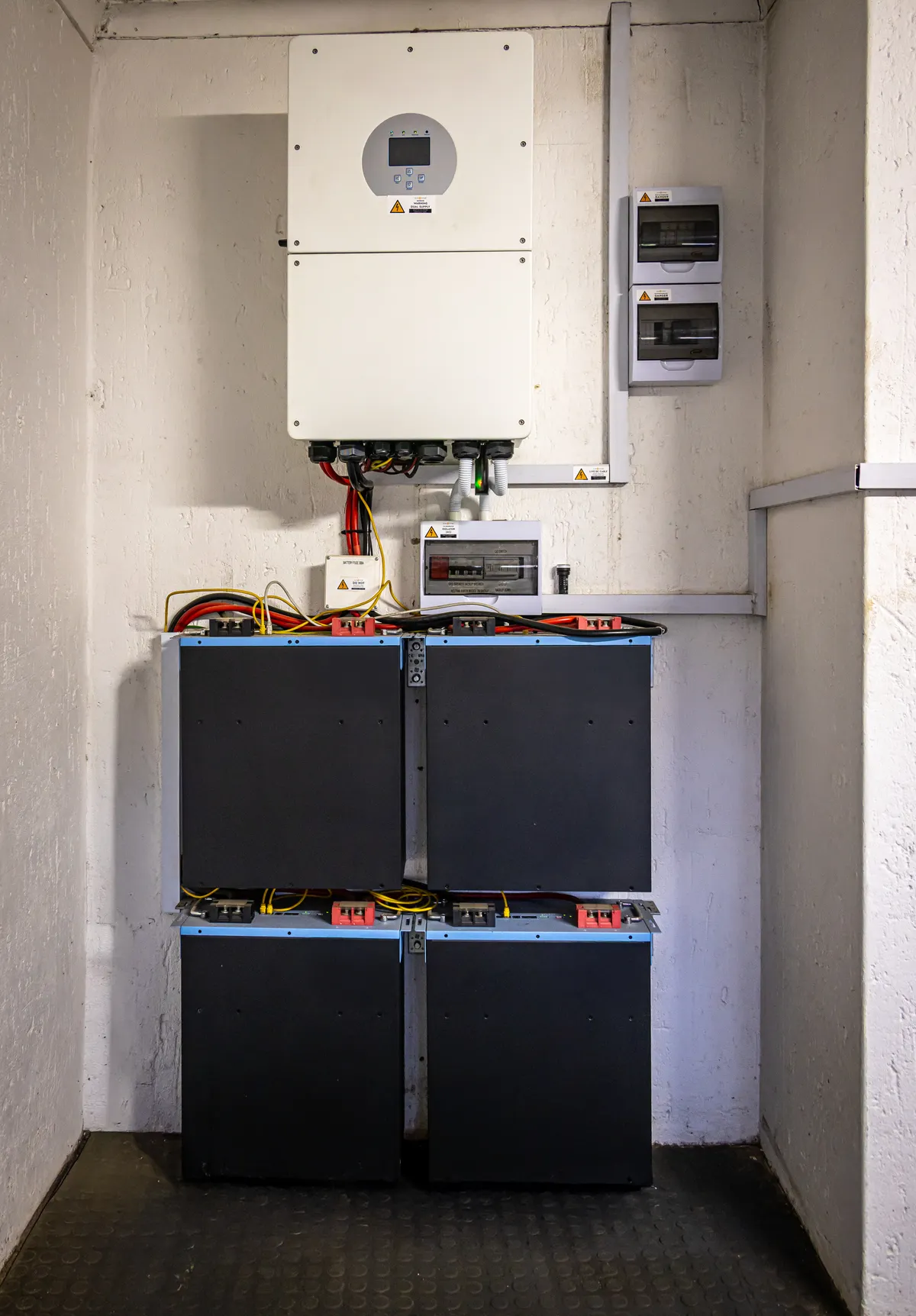 Home battery storage modules and inverter installed in a garage