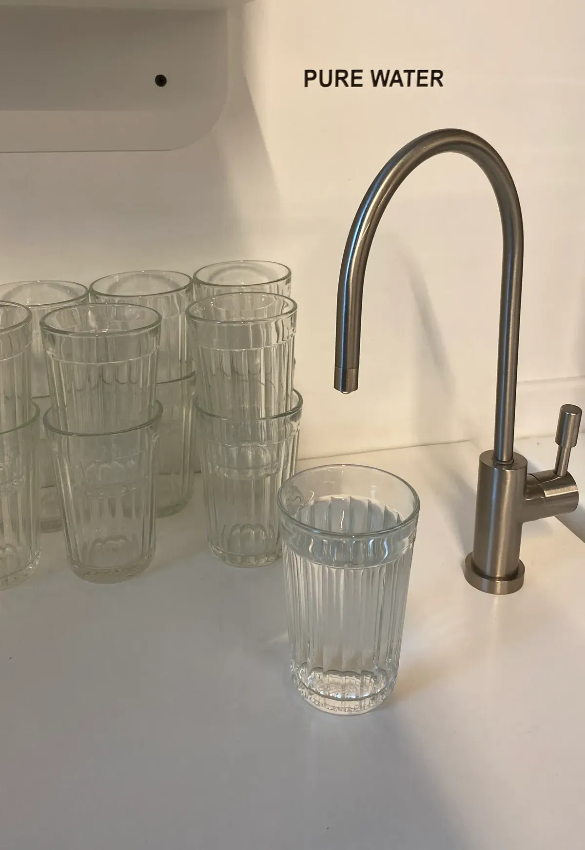 Dedicated filtered water tap on a kitchen bench fed by an under-sink filter
