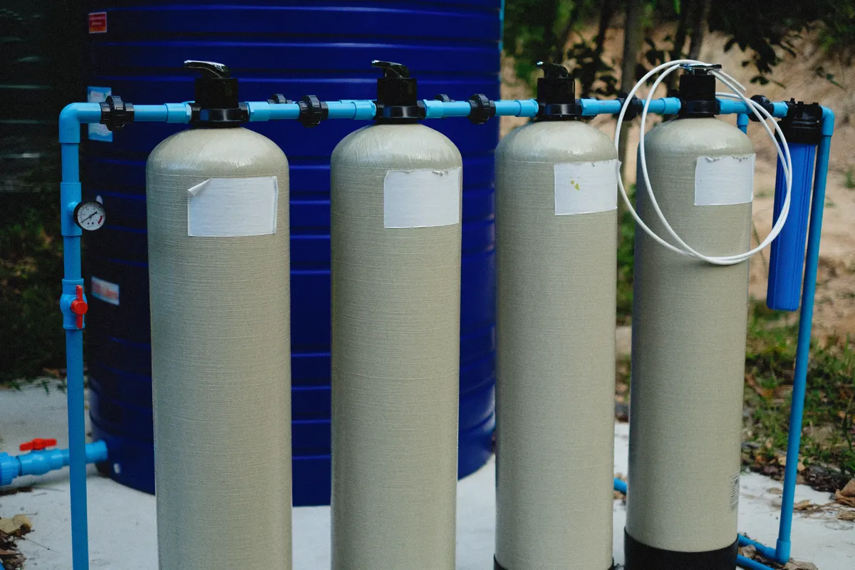 Whole-house water filtration tanks plumbed to a home water supply